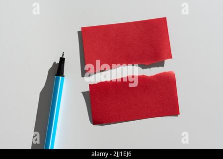 Ripped Sticky Note With Important Messages Presented On Desk With Pen. Teared Apart Memo With Two Different Crutial Informations. Recent Announcements Stock Photo