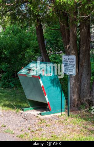 Eagle River, MI - June 22, 2022: Animal proof trash receptacle in public park Stock Photo