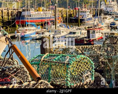 Lobster pots and boats in South Bay Harbour, Scarborough, UK Stock Photo