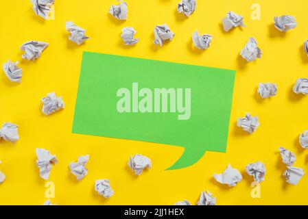Paper Wraps Placed Around Speech Bubble With Important Information. Wrinkled Notes Arranged All Over Dialogue Ballon With Crutial Message. Crumpled Stock Photo