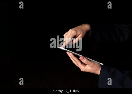Businesswoman Holding Tablet And Pointing With One Finger On Important Message. Executive In Suit Presenting Crutial Information. Woman Showing Stock Photo