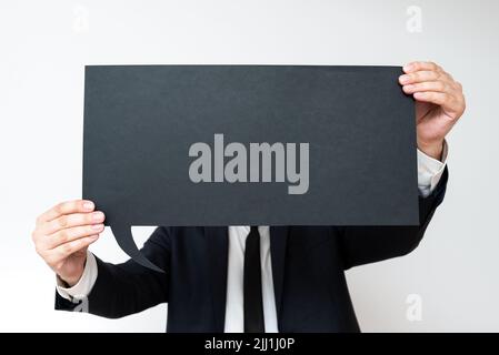 Businessman Holding Speech Bubble With Important Messages. Man In Suit Presenting Crutial Informations On Dialogue Balloon. Gentleman Showing Recent Stock Photo