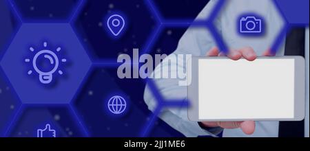 Businessman Holding A Tablet Showing Glowing Digital S In A Graphic Hexagon Frame. A Hand With A Touch Screen Displaying Global Connection And Stock Photo