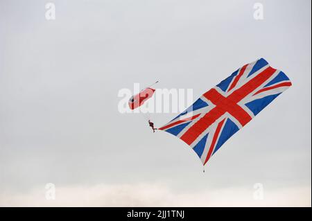 A member of the Red Falcons Parachute Team coming into land during a display jump at the Farnborough International Airshow (FIA) which is taking place in Farnborough, Hampshire, UK.  The air show, a biannual showcase for the aviation industry, is the biggest of its kind and attracts civil and military buyers from all over the world. trade visitors are normally in excess of 100,000 people. The trade side of the show is followed by a weekend of air displays aimed at the general public.  A huge amount of business is done at the show and the last show in 2018 saw US$192 billion worth of business d Stock Photo