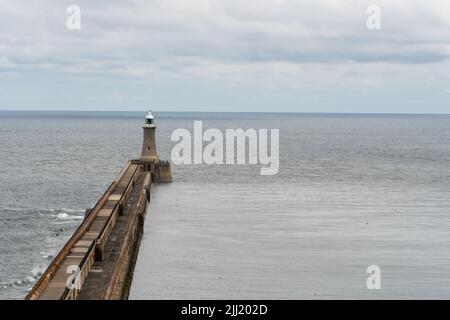 A view of Tynemouth pier, with lighthouse at the mouth of the River Tyne, in Tynemouth, North Tyneside, UK. Stock Photo