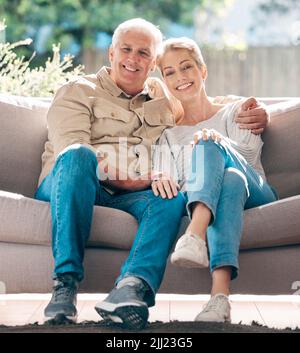 The best life partner by far. Portrait of a happy senior couple relaxing on the sofa at home. Stock Photo