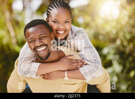 Im holding on and never letting go. an affectionate couple spending time outdoors. Stock Photo