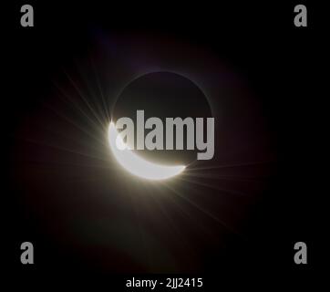 The last glimmer of the sun is seen as the moon makes its final move over the sun during the total solar eclipse on Monday, August 21, 2017 above Madras, Oregon. A total solar eclipse swept across a narrow portion of the contiguous United States from Lincoln Beach, Oregon to Charleston, South Carolina. A partial solar eclipse was visible across the entire North American continent along with parts of South America, Africa, and Europe.  Photo Credit: (NASA/Aubrey Gemignani) Stock Photo