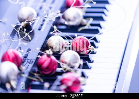 A colorful chain of lights lies on piano keys Stock Photo