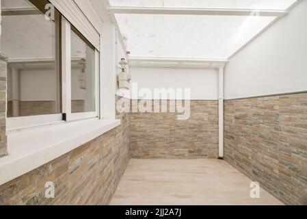 Drying terrace with white aluminum windows and glass in the kitchen of an apartment and semi-transparent plastic ceiling Stock Photo
