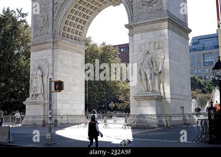 New York, NY, USA - July 22, 2022: The Washington Square Arch having been power washed surrounded with barricades to prevent new graffiti Stock Photo