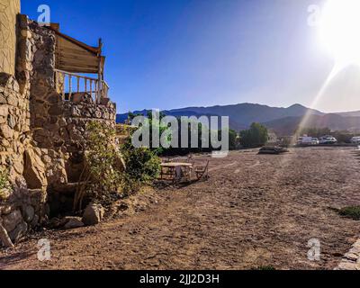 Cottage in a Bedouin Camp on the Sea in Ras Shitan in Oasis in Sinai, Taba desert with the Background of the Sea and Mountains. Stock Photo