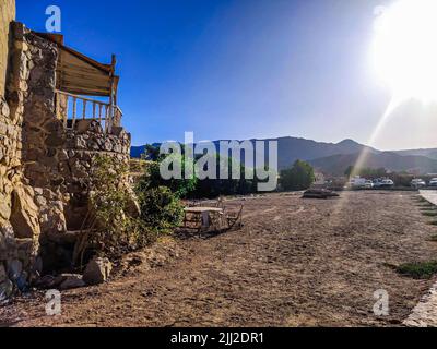 Cottage in a Bedouin Camp on the Sea in Ras Shitan in Oasis in Sinai, Taba desert with the Background of the Sea and Mountains. Stock Photo