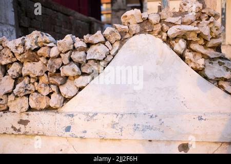 Fence made from small rounded stones. Close up view Stock Photo