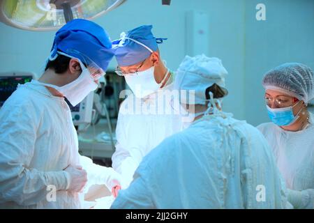 Surgeons during the operation. Professional doctors performing surgeries. Stock Photo