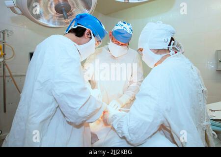 Surgeons during the operation. Professional doctors performing surgeries. Stock Photo