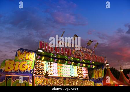 COSTA MESA, CALIFORNIA - 20 JUL 2022: Party Zone carnival game at the Orange County Fair with blue hour sunset sky. Stock Photo