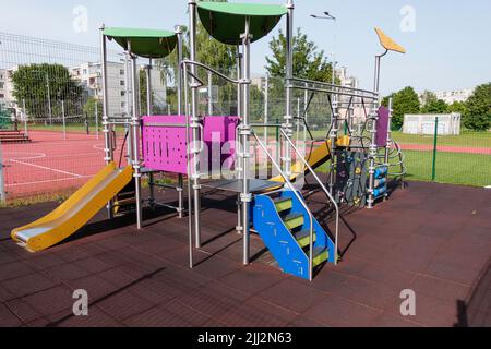 Colorful children playground near sports field stadium in the city Stock Photo