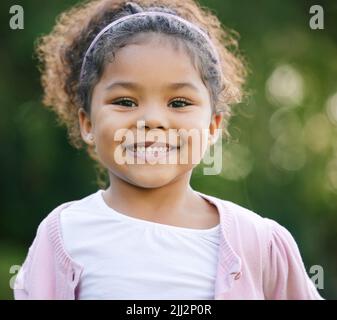 Childhood is the most beautiful of all lifes seasons. Portrait of an adorable little girl having fun outdoors. Stock Photo