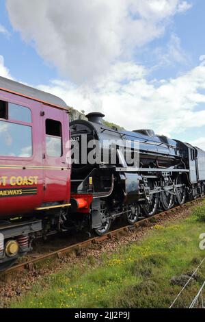 Jacobite steam train 45212 in Mallaig. The Jacobite is a steam locomotive-hauled tourist train service that operates over part of the West Highland. Stock Photo