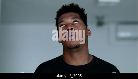 Annoyed bored black man rolling eyes Stock Photo