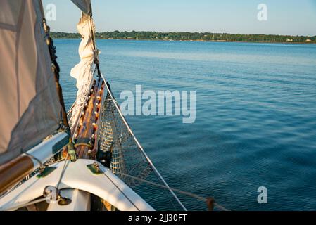 Sails folded and lashed to the bow on the Atalntic Ocean in Maine Stock Photo