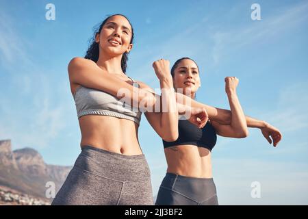 Warming those muscles up. two friends stretching before a workout. Stock Photo