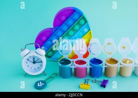Close-up of stationery and a silicone toy. The composition of a flat layer. Blue background. Space for the text. Back to school Stock Photo