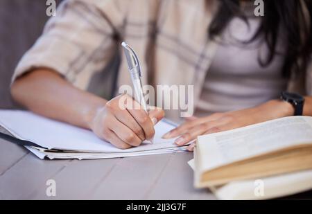 Working out my steps going forward. an unrecognizable student studying at home. Stock Photo