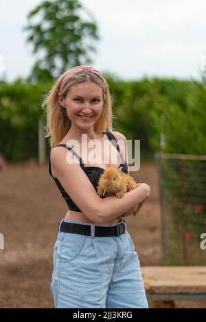 Rabbit easter bunny holding girl cute furry friendship attractive happy, concept hands woman from young from farm rodent, mammal hug. Sunny funny, Stock Photo