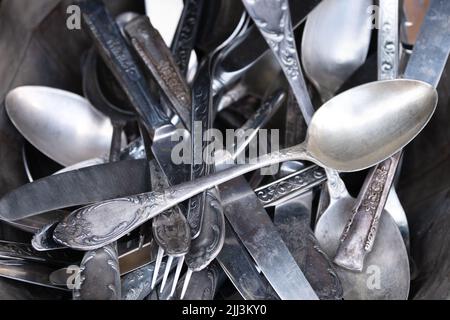 Pile of old silver forks,spoons and knifes in a silver bowl Stock Photo