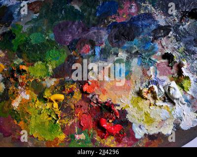 AJAXNETPHOTO. 2021. WORTHING, ENGLAND. - COLOUR PALETTE - A PAINTER'S WOODEN PALETTE COVERED IN A MESS OF OIL-PAINT COLOURS.PHOTO:JONATHAN EASTLAND/AJAX REF:GX9 211209 2464 2 Stock Photo