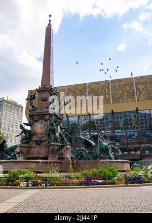 Leipzig, Germany - June 25, 2022: The Mendebrunnen at the Augustus square. The water fountain in front of the Gewandhaus. Bronze figure are grouped ar Stock Photo