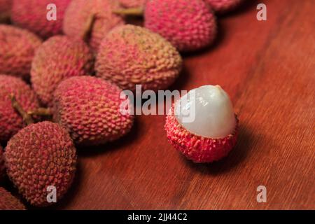 Fruit Lichia - They are small fruits, with reddish skin and roughness. Its pulp is white and juicy, with a sweet and slightly acidic flavor. Stock Photo
