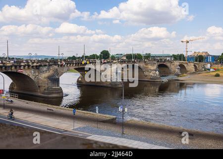 Dresden, Germany - June 28, 2022: Panoramic view over the Terrassenufer to the river Elbe meadows (Elbwiesen) with the Carolabruecke on the horizon. Stock Photo