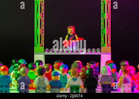 Bauru, Brazil. June 1, 2022: Lego rock star minifigure playing guitar and performing a solo concert on stage with thousands of spectators watching and Stock Photo