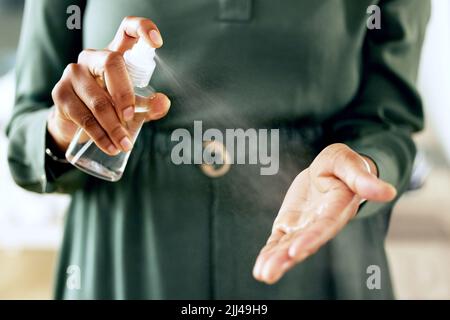 Keeping my hands germ free. an unrecognizable businessperson sanitising their hands at work. Stock Photo