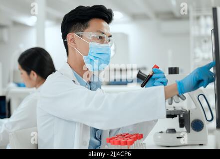 Doing high level research. a young male scientist working in a lab. Stock Photo