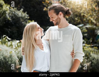 Be with someone who makes you feel like this. an affectionate couple standing outside. Stock Photo