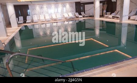 EIN BOKEK, Israel - 6 July 2022: Ein Bokek Spa swimming pool. Indoor pool with mineral salty water in hotel at the Dead Sea resort Israel. Stock Photo