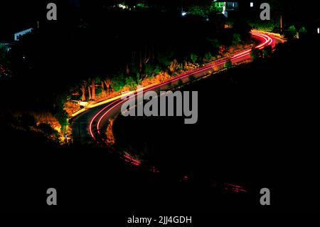 Light trails on a mountain road Stock Photo