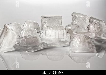 natural ice cubes on a light background, dissolving cubes of a dripping texture Stock Photo