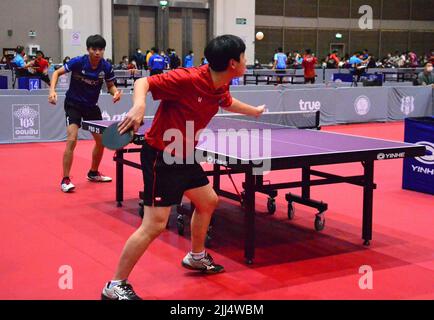 July 23rd, 2022. Teenage boy table tennis players play at the table tennis and badminton sports event 'BBG Princess Cup 2022' where participants compete to win the trophy of Her Royal Highness Princess Maha Chakri Sirindhorn at Royal Paragon Hall, Siam Paragon Shopping Center, Pathumwan District, Bangkok, Thailand, Asia. Stock Photo