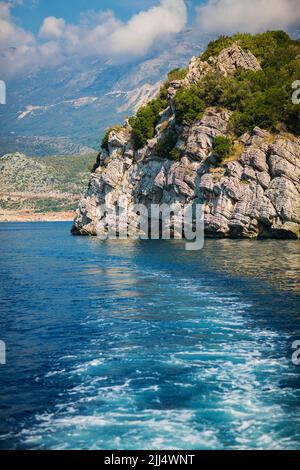 Wave trace tails of speed boat on blue water surface in the sea Stock Photo