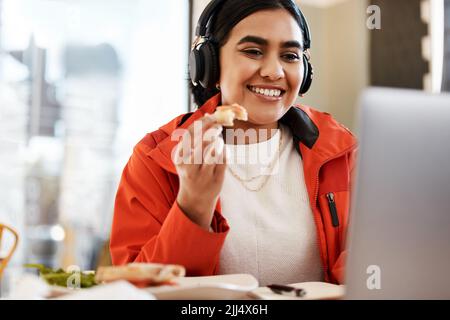 Dedicated to being the best student I can be. a young female student using a laptop while studying at college. Stock Photo