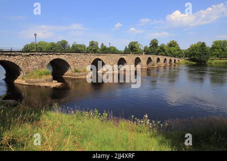The long stone arch bridge from the 18th century bridges over the river Klaralven in  Karlstad city. Stock Photo
