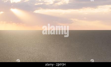Sun setting over the asphalt empty road Stock Photo