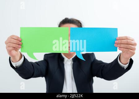 Businesswoman Holding Two Speech Bubbles With Important Messages. Woman Presenting Crutial Informations On Different Dialogue Balloons. Lady Showing Stock Photo