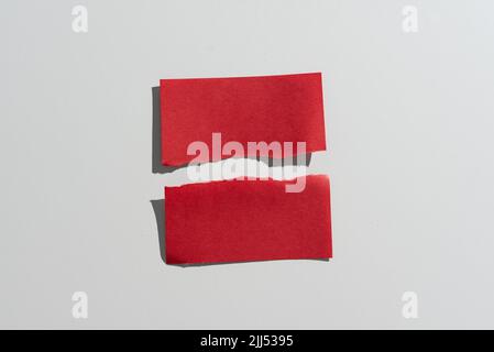 Ripped Sticky Note With Important Messages Presented On Desk. Teared Apart Memo With Two Different Crutial Informations. Recent Announcements Stock Photo