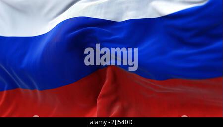 Close-up view of the Russian national flag waving in the wind. Russia is a transcontinental country spanning Eastern Europe and Northern Asia Stock Photo